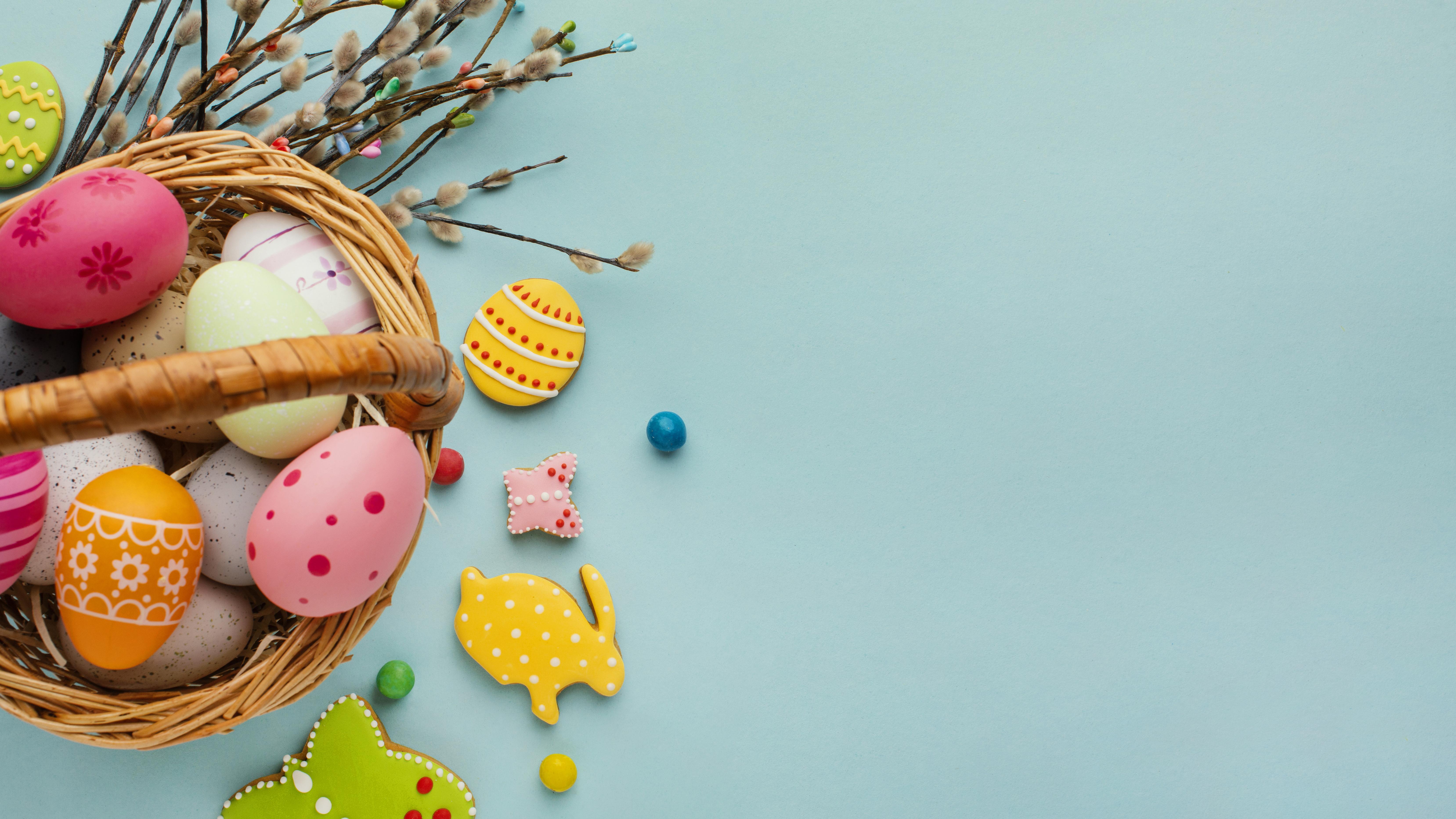 flat-lay-of-easter-eggs-in-basket-with-bunny-and-butterfly-shapes
